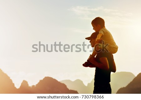Happy son piggybacking on father and having fun together. Travel flight concept. Space for text