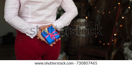 Blurred image of female holding bright present boxes with ribbons. Happy holidays and Merry Christmas concept.