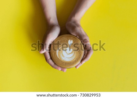woman holding hot cup of coffee