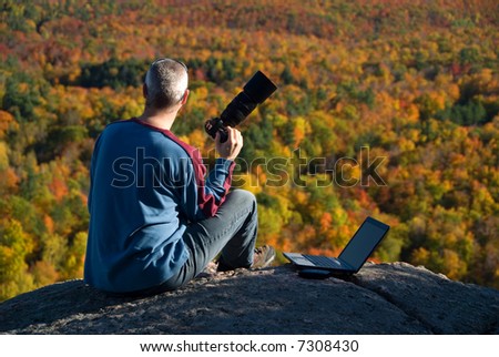 male photographer shooting at the top of a mountain