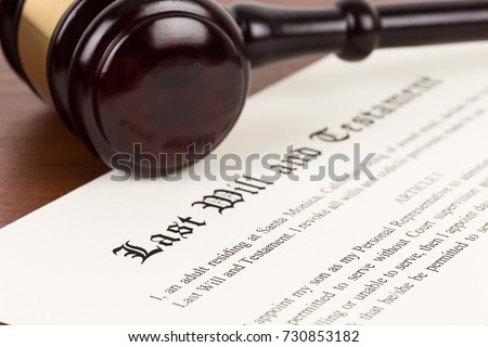 Last will and testament on yellowish paper with wooden judge gavel; document is mock-up Royalty-Free Stock Photo #730853182