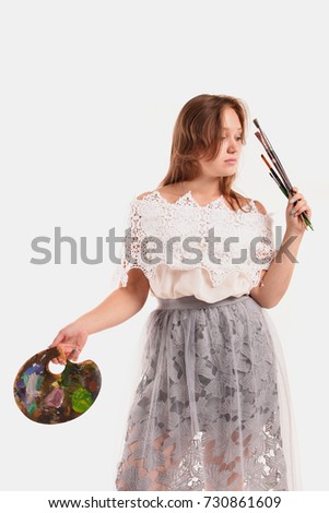 Girl artist on a white background isolated in studio