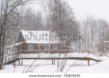 A wooden house tourist base of the mountain in the winter forest. Heavy snowfall