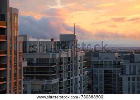 Brilliant Colorful Sunset Over Condo Buildings With Cityscape In The Background In Vaughan Ontario Canada Royalty-Free Stock Photo #730888900