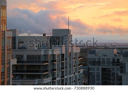 Brilliant Colorful Sunset Over Condo Buildings With Cityscape In The Background In Vaughan Ontario Canada Royalty-Free Stock Photo #730888930