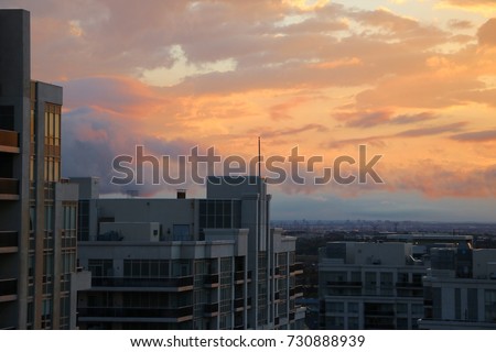 Brilliant Colorful Sunset Over Condo Buildings With Cityscape In The Background In Vaughan Ontario Canada Royalty-Free Stock Photo #730888939