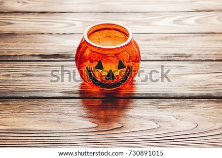 happy halloween concept. jack o lantern autumn pumpkin with scary face on wooden background with space for text. seasonal greetings, fall holidays. harvest time. trick or treat
