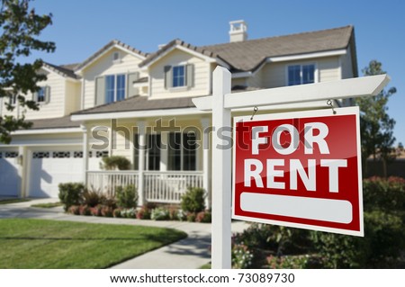 Left Facing Red For Rent Real Estate Sign in Front of Beautiful House. Royalty-Free Stock Photo #73089730
