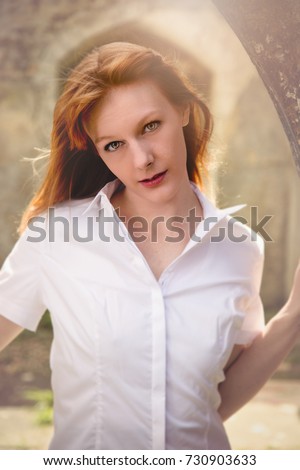 Female model portrait out side, natural light, summer fresh. Red hair. Bright summer light