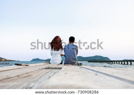 love couple traveler looking for view Island and the sea.Asian tourist sit on the bridge in to the sea on holiday.couple enjoying view of nature on vacation.cinematic photography film  tone style