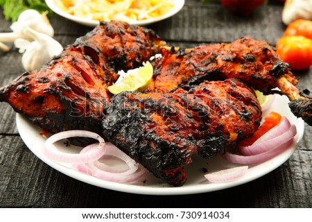 Arabian food concept- fried chicken in flame. Royalty-Free Stock Photo #730914034
