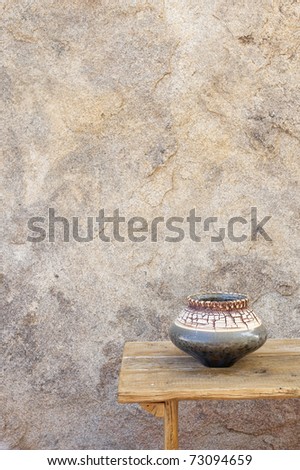 Outdoor home area with a wood table and ceramic bowl.
