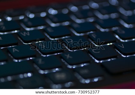 Illuminated keyboard. Focus on WASD keys. Shallow depth of field