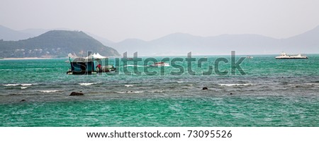 Tropical sea bay with coral reef and boats