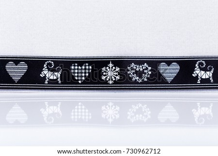 holiday christmas background, black ribbon with pictures on white