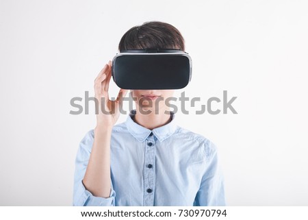 Girl in virtual reality headset on white background