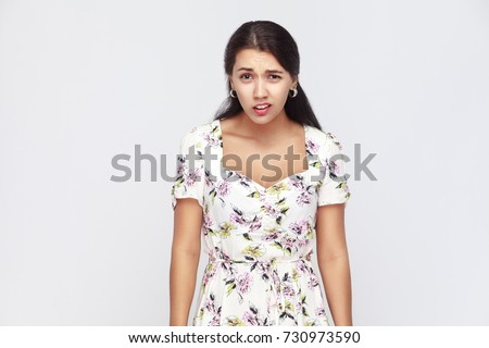 The sneer woman looking at camera and mockery over someone. Indoor, studio shot. Gray wall Royalty-Free Stock Photo #730973590