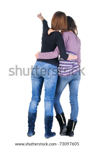 Back view of two women pointing at wall. Rear view. Isolated over white.