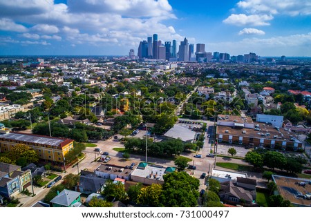 Houston , Texas aerial drone view above homes and the surrounding area of Houston Texas with downtown skyline cityscape in the background