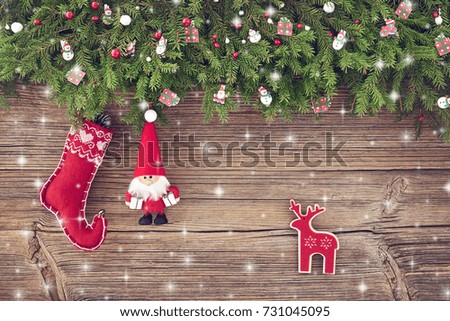 Christmas background. Christmas decoration with Santa and red Christmas sock on wooden background with snow. Copy space, top view                               