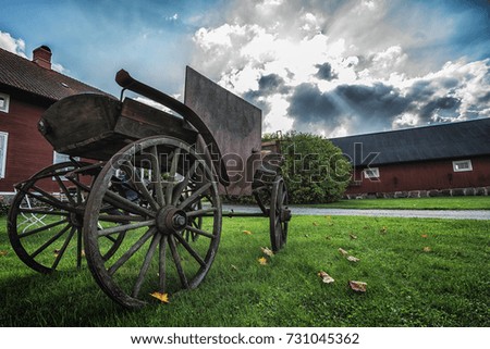Picture of old wooden cart at the country side with blue sky.