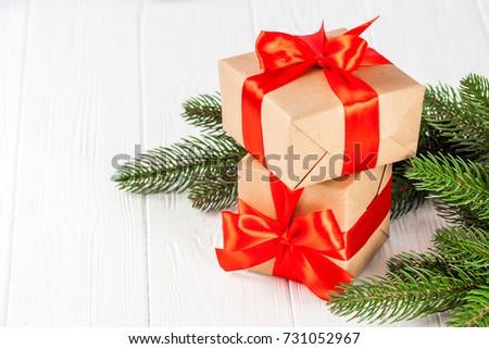 Christmas banner with green tree and present boxes with ribbon and bow on wooden background. Xmas and New Year congratulation card with copy space.
