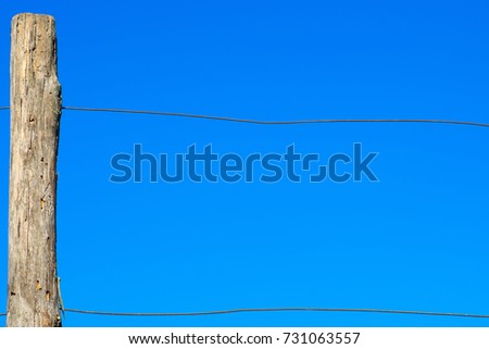  wooden pole and metal wire fence. Abstract image. Border or limit concept.