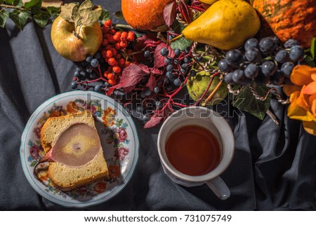 Dessert - pie with pear and apple and cup of tea, fruits and flowers on the table. Healthy fresh food and drink. Country style.