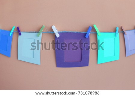 Clothespin with colorful frame card hanging on rope