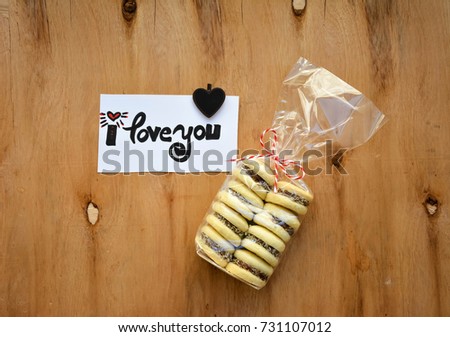Cookies in a gift bag and i love you text on a note on a wooden table