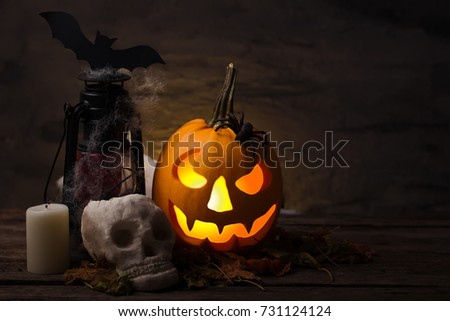 Scary halloween pumpkin with skull in a spooky night. Halloween scene.