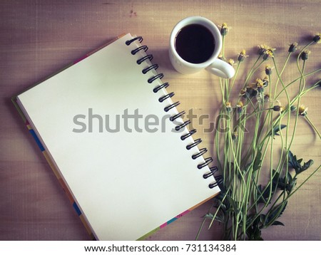 top view and copy space of note paper and coffee cup on desk table with flower