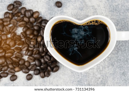 top view of coffee cup heart shape and coffee bean on concrete background