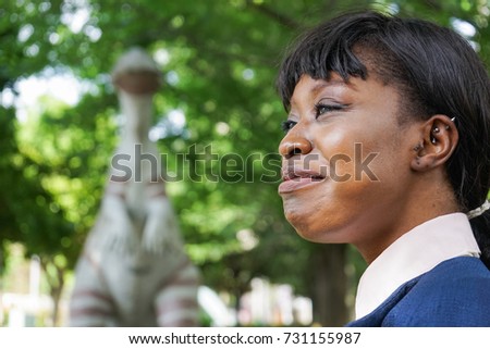 african woman being surprised at dinosaur