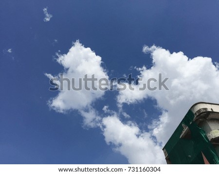 Blue sky with white cloud and old building
