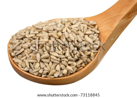 Sunflower seeds in a wooden spoon on a white background