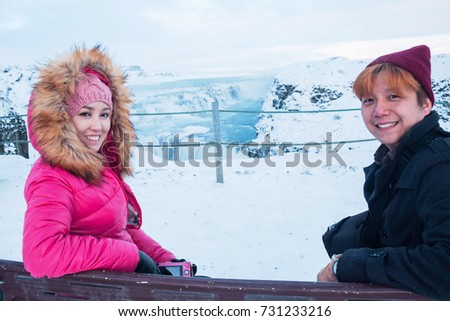 Gullfoss waterfall view in the canyon of the Hvita river during winter snow Iceland with Asian couple