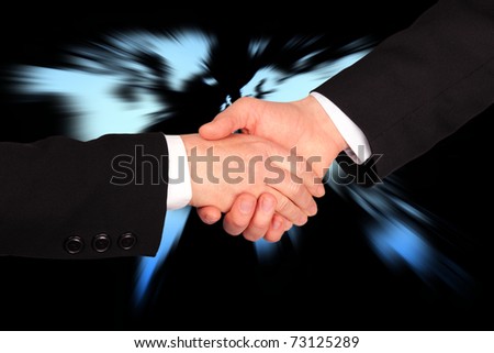 Hand shaking in business with world map in background