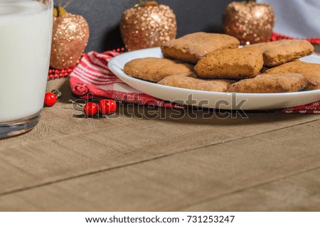 Biscuits and milk on a red napkin in Christmas decor with free space for text