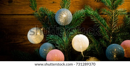 Christmas fir tree with decoration on wooden board