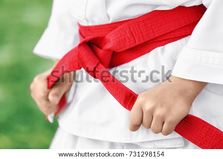 Little child in karategi outdoors, closeup