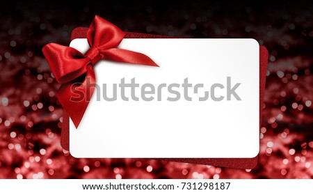 christmas gift card with red bow on blurred bright lights, template copy space