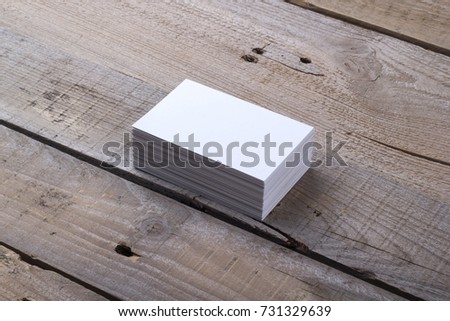 Photo of business cards. Template isolated on old wood background. For graphic designers presentations and portfolios damaged weathered antique mock-up with business cards
