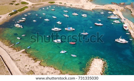 Aerial birds eye view photo taken by drone depicting beautiful port with deep blue - turquoise waters, Koufonisi island, Cyclades, Greece