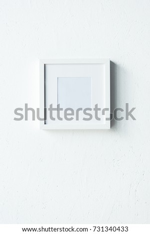 close up view of empty photo frame hanging on wall