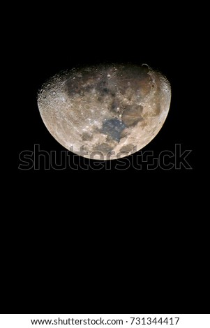 Half moon seen with an astronomical telescope, with enhanced colour to show the real colours of terrain surface.