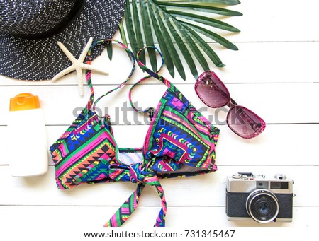 Summer Fashion woman big hat and accessories, vintage camera and sunglasses go to travel in the beach. Tropical sea.Unusual top view,  background.  Summer Concept.
