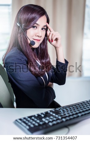 Smiling asian businesswoman using headset against elegane wooden interior room business ideas concept