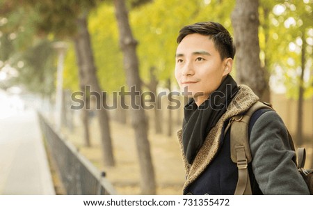 Handsome Asian men who admire the scenery in the park
