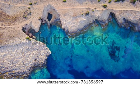 Summer 2017: Aerial birds eye view photo taken by drone depicting beautiful caves with deep blue - turquoise waters
